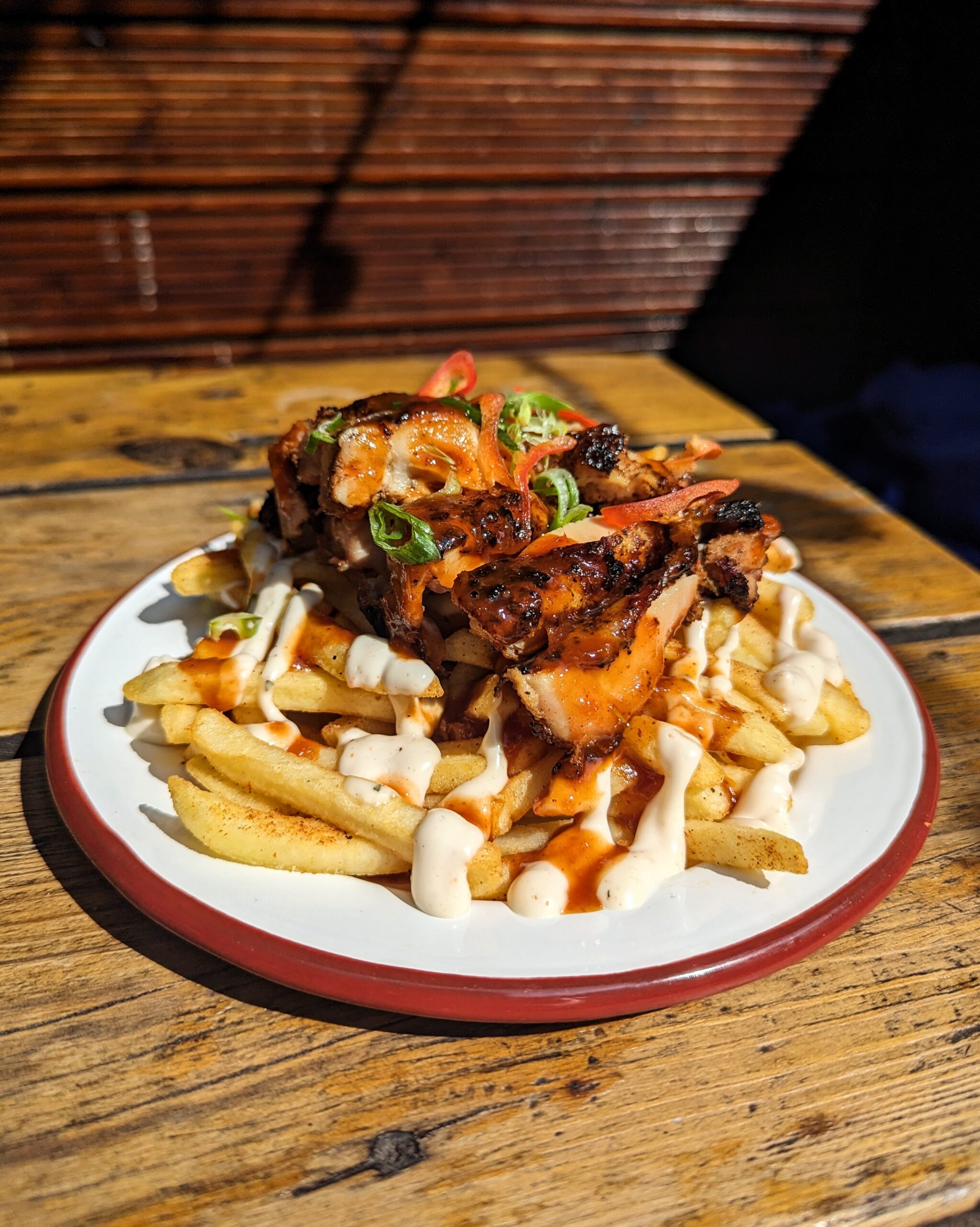 Jerk chicken and chips with sauce and herbs