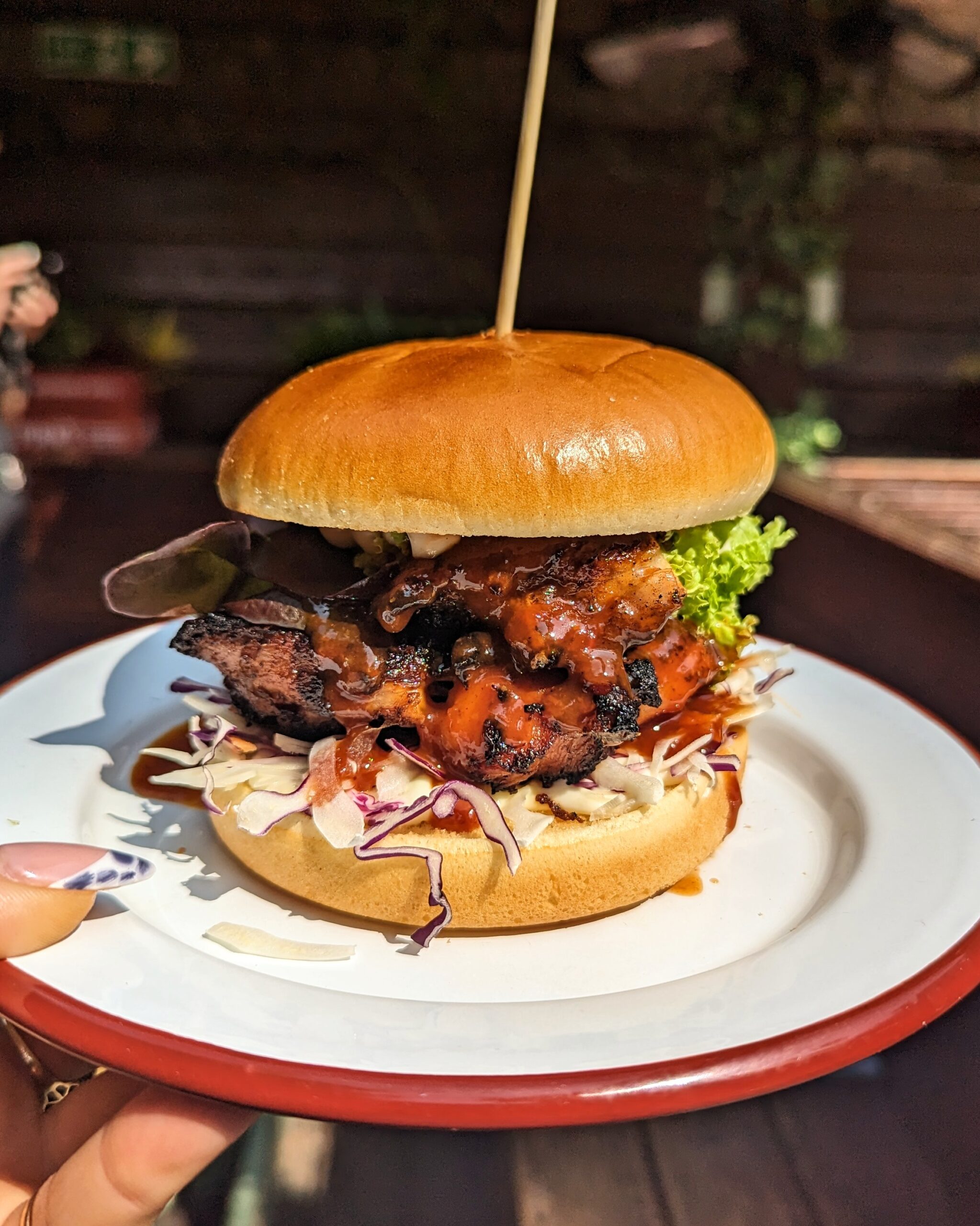 Jerk chicken burger with slaw and salad